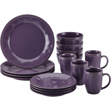 the purple dishes are stacked on top of each other with matching cups and saucers