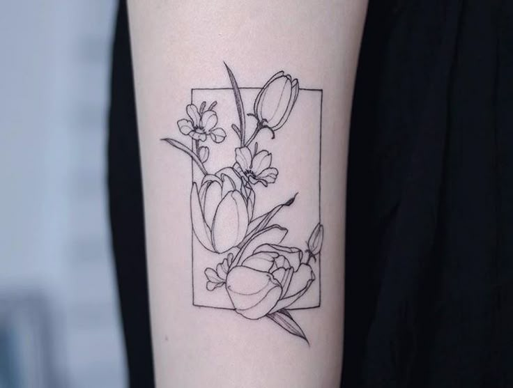 a woman's arm with a flower tattoo on the left side of her arm