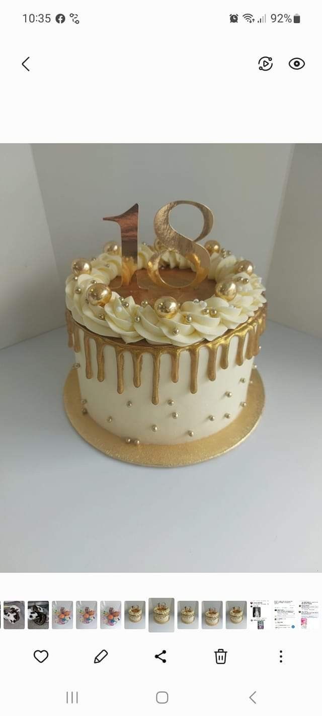 the cake is decorated with gold and white icing on it's own side