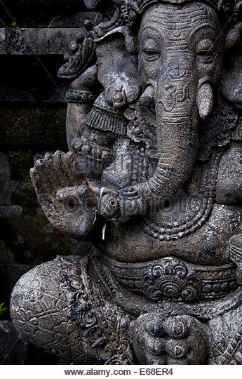 an elephant statue in front of a stone wall