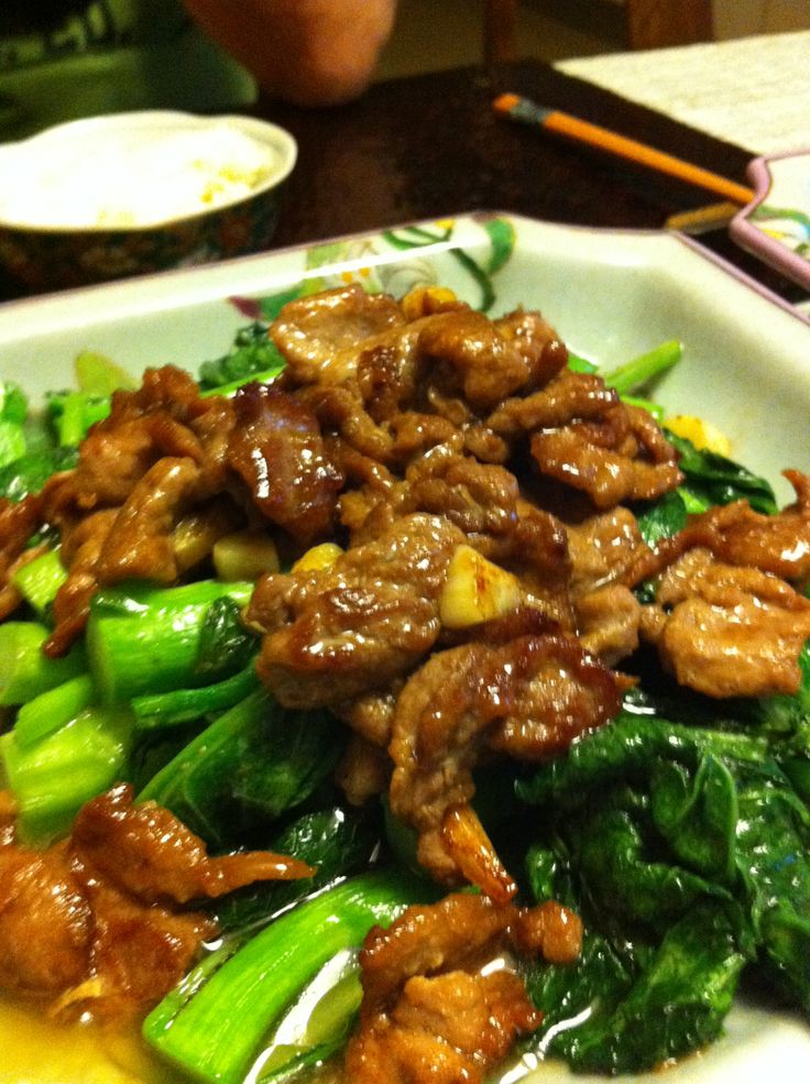 a white plate topped with meat and veggies