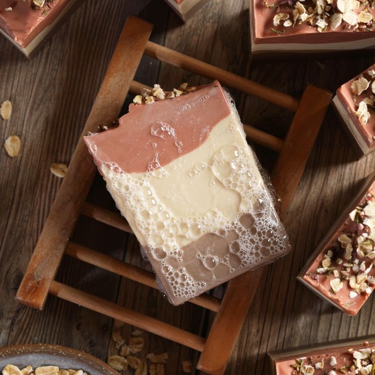 several pieces of cake sitting on top of a wooden table