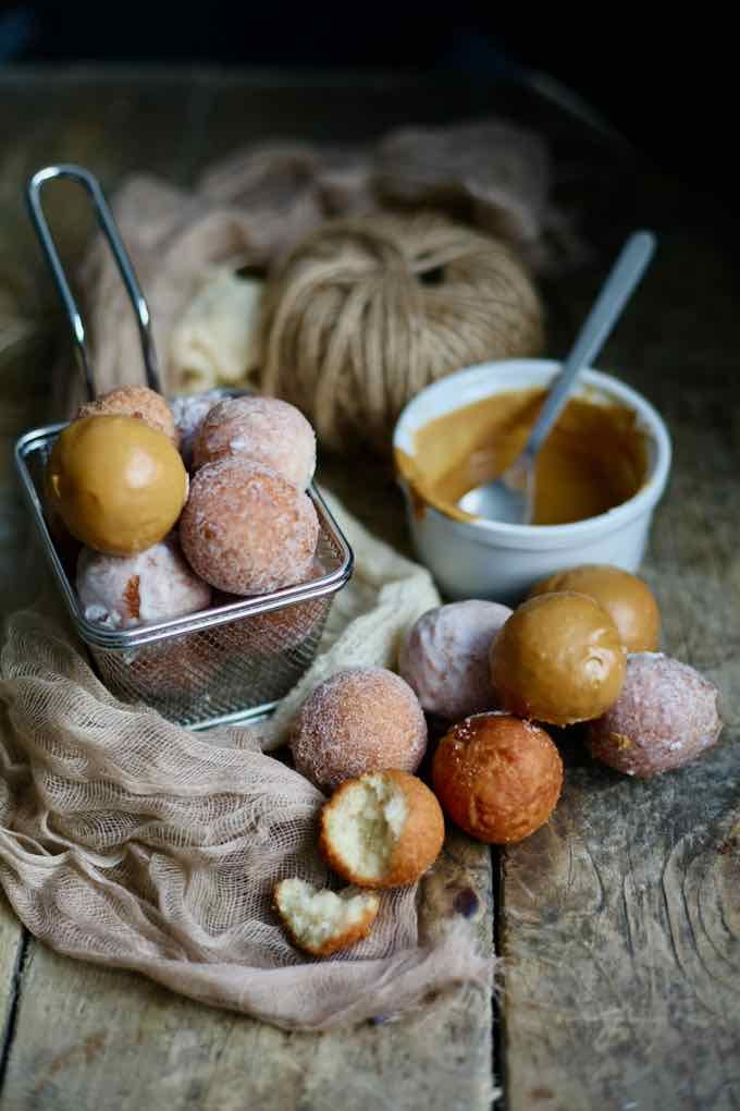 some doughnuts are sitting on a wooden table