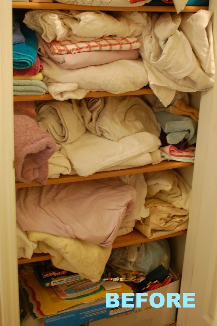 an open closet filled with clothes and other items to be used as storage for clothing