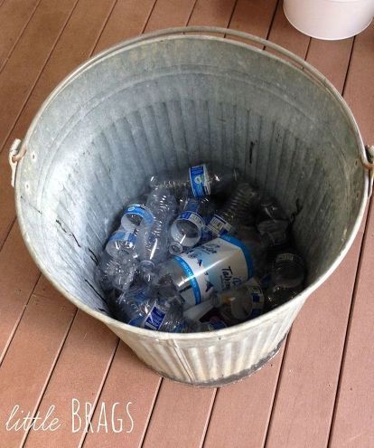 a bucket full of water sitting on top of a wooden floor