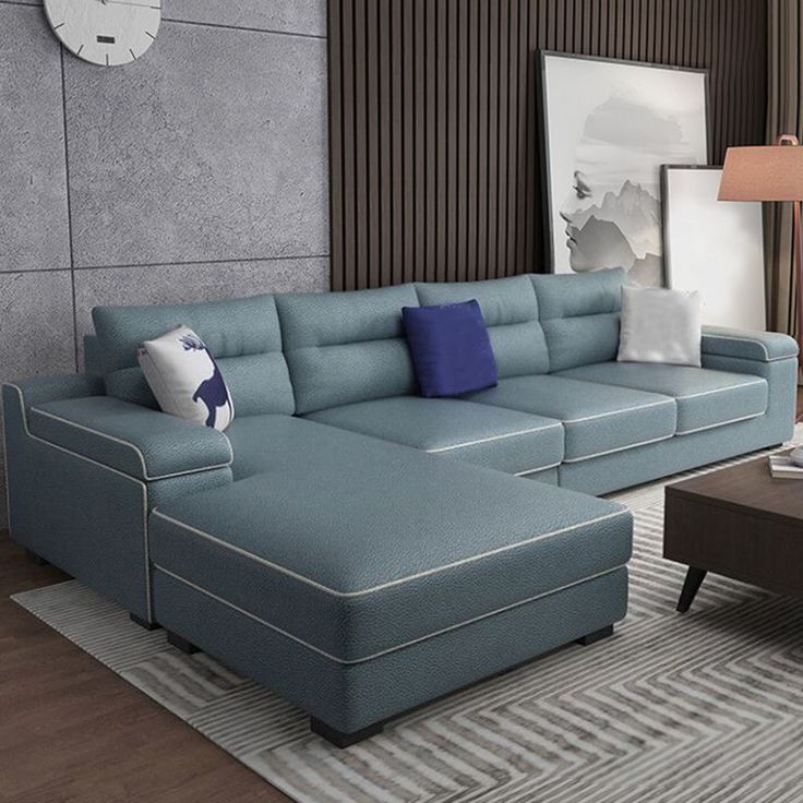 a living room with a large blue sectional couch