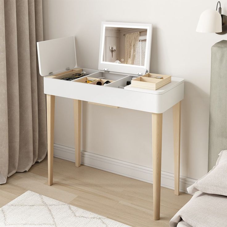 a white desk with a mirror and drawers on it