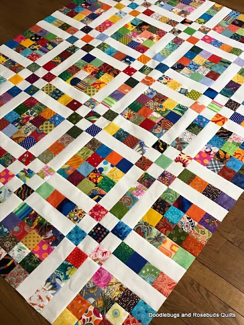 a colorful quilt is laying on the floor