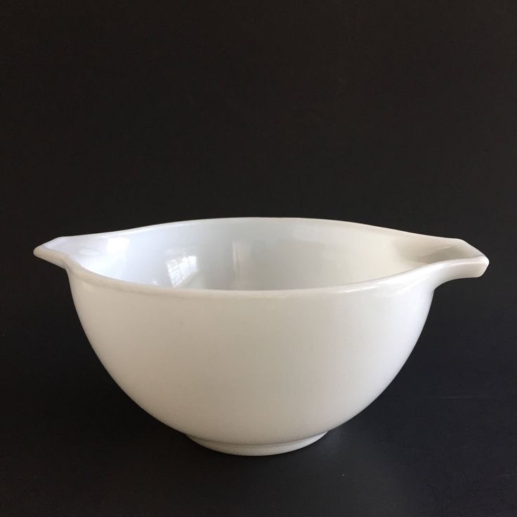 a white bowl on a black table