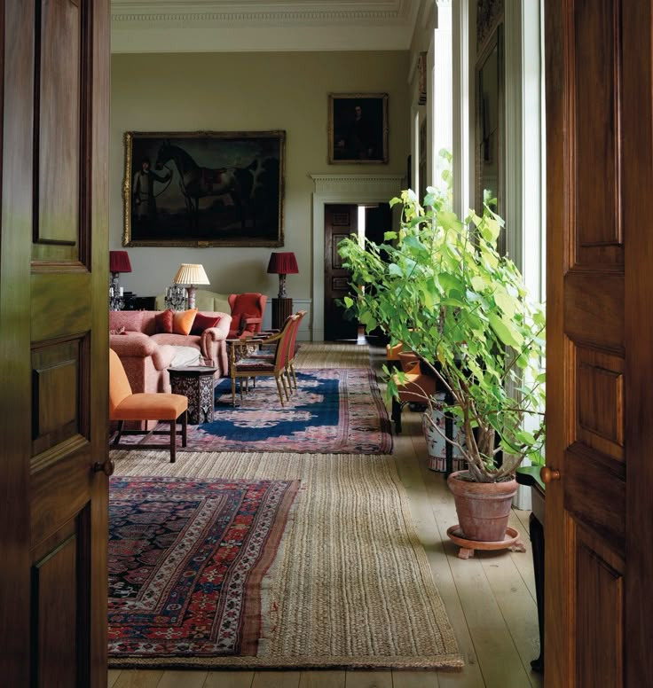 an open door leading to a living room with chairs and rugs