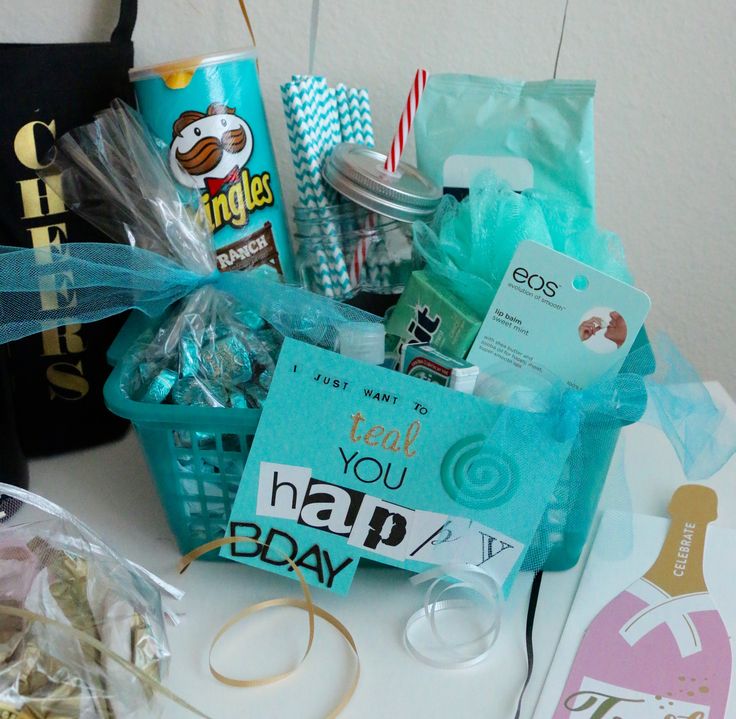 a basket filled with lots of items on top of a white table next to a black bag