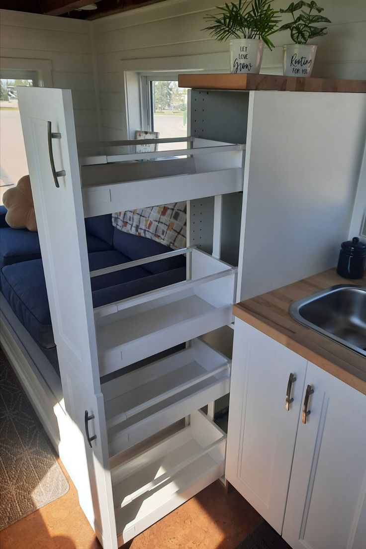 a kitchen area with a sink and bunk bed