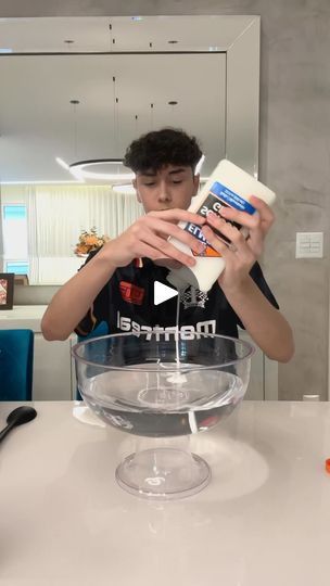 a boy is mixing something in a bowl