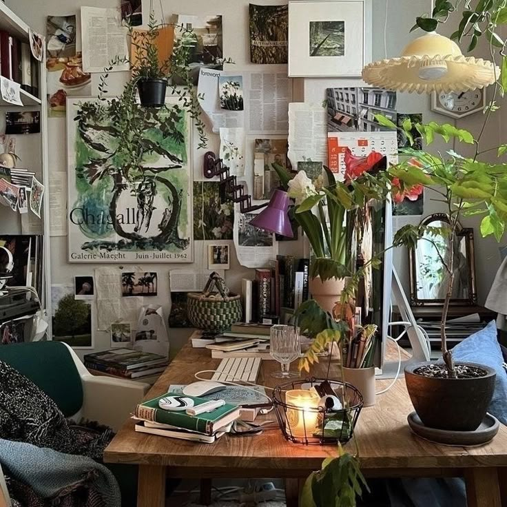 a living room filled with lots of plants and pictures on the wall above it's table