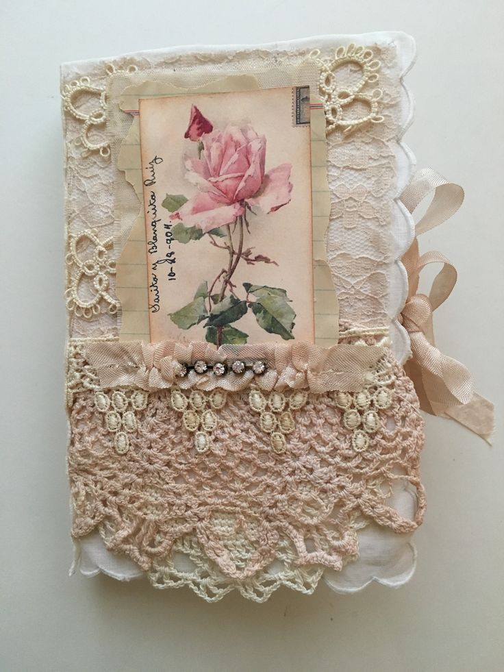 an altered photo with lace and pink rose on the front, attached to a white wall