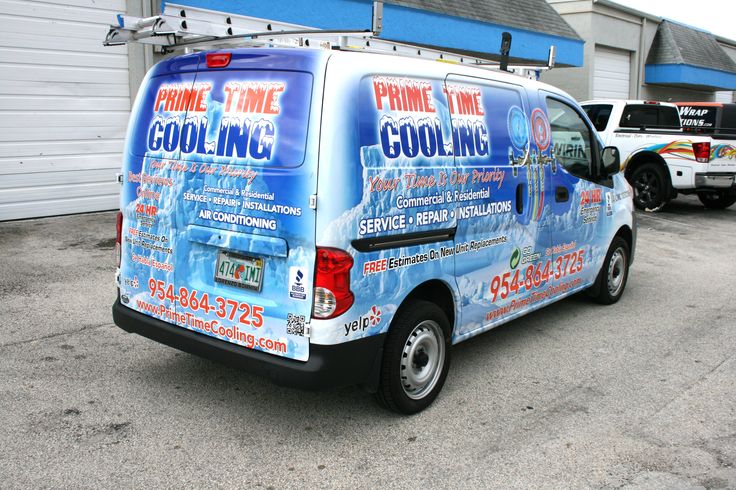 a blue van parked in front of a building