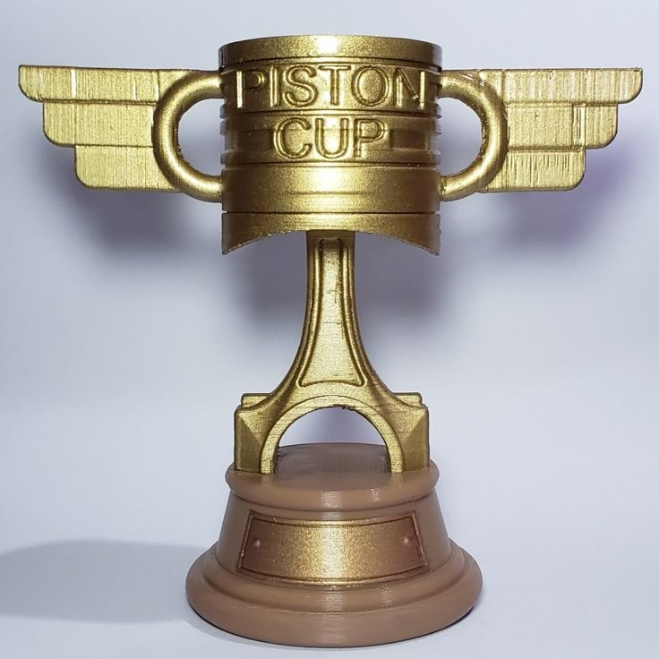 a golden cup with wings and the word'stop cup'written on its side