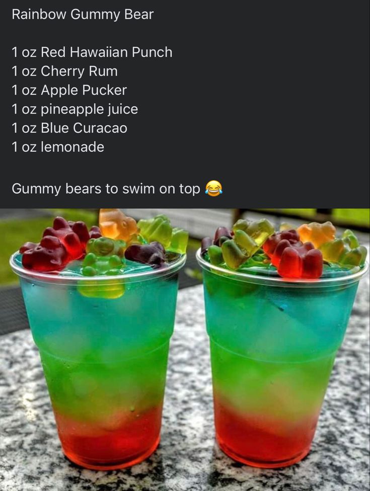 two drinks with gummy bears in them sitting on a table next to each other