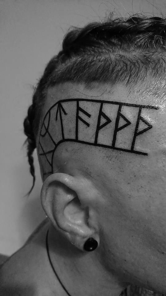 a man has his face painted with letters