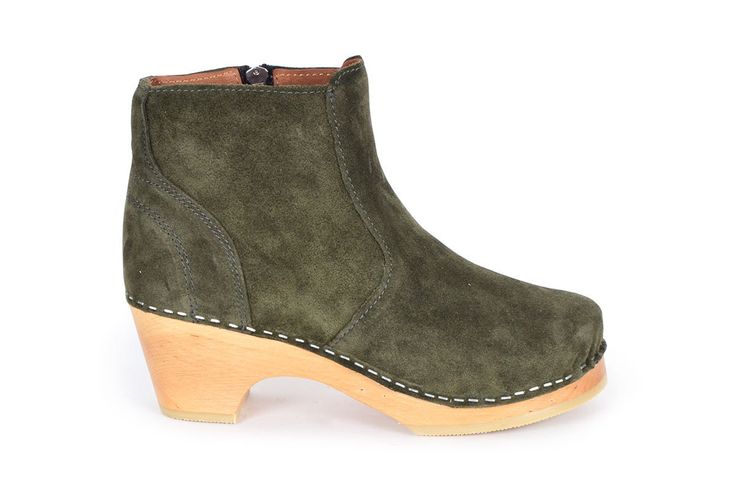 Auckland has a classic boot shape with zipper closure on the inside. Here in Moss Green suede leather with soft leather lining and on our natural low heel. The boots fits medium width foot. Heel height: 7 cm Platform height: 2.5 cm Fit: Medium width Leather Upper: Green suede leather Lining: Soft leather lining Wood: Varnished alderwood Footbed: Natural wood for excellent moist absorption Swedish Clogs, Suede Clogs, Clog Boots, Classic Boots, Green Suede, Moss Green, Auckland, Brown Suede, Boot Shoes Women