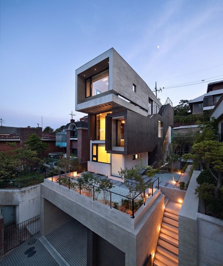 a modern house with stairs leading up to it