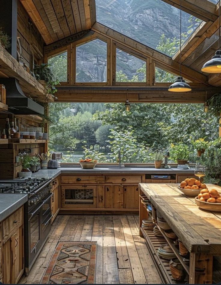 a kitchen with wooden floors and an open roof over the stove top oven, surrounded by greenery