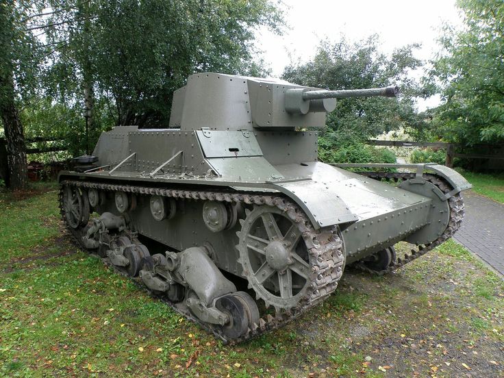 an old tank is sitting in the grass