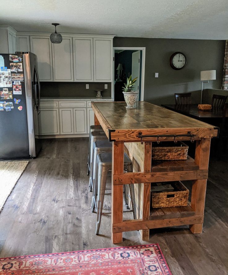 a kitchen with an island made out of wood