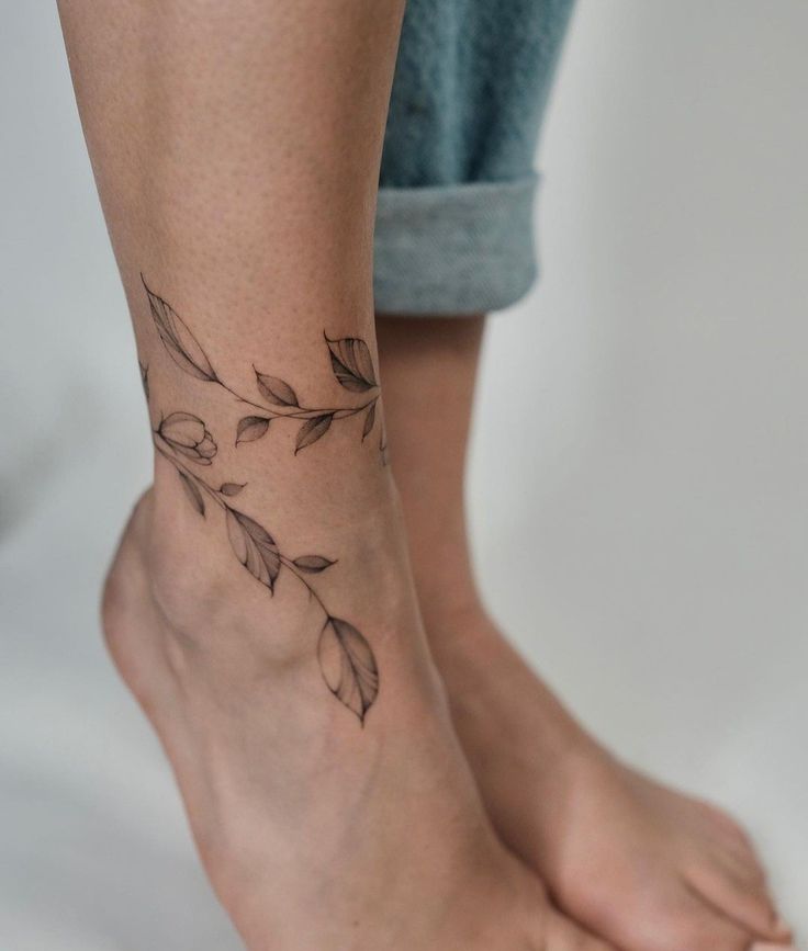 a woman's foot with a small tattoo on the left side of her leg