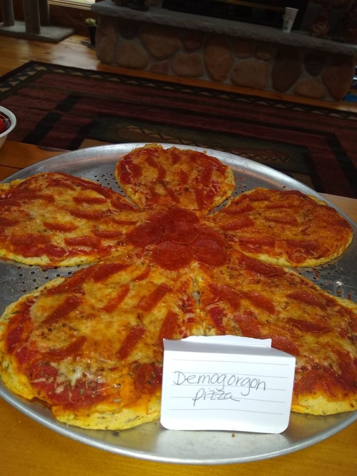 a pizza sitting on top of a pan covered in cheese