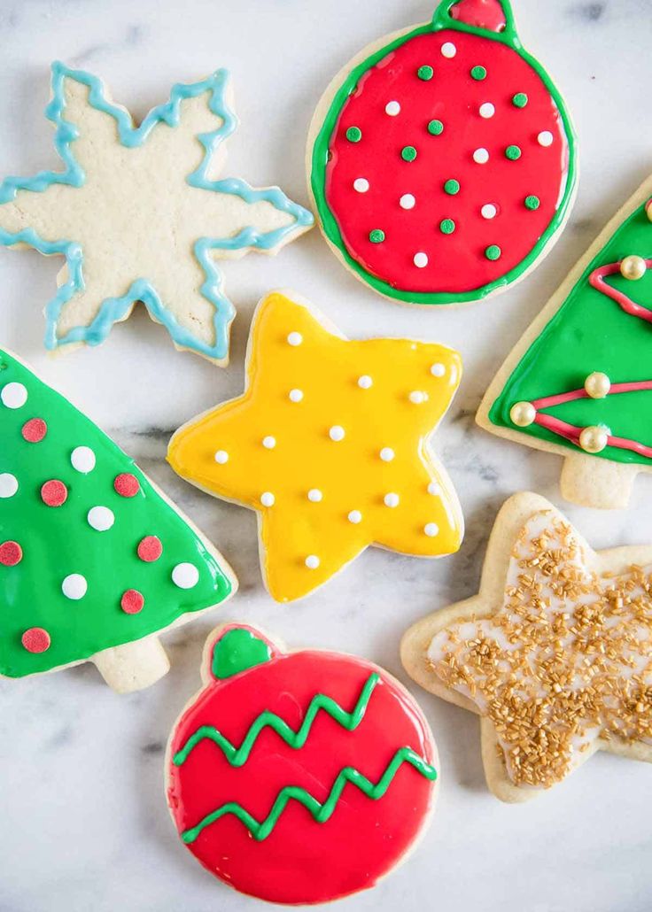 decorated christmas cookies on a marble surface