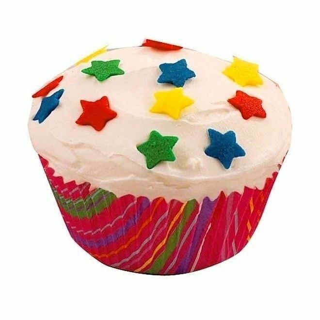 a cupcake with white frosting and colorful stars on it