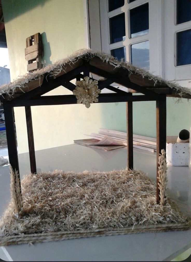 a small house made out of hay on top of a table