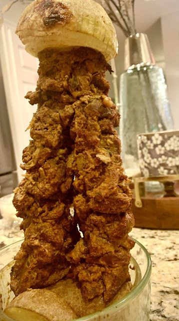 a stack of fried food sitting on top of a glass bowl next to a counter