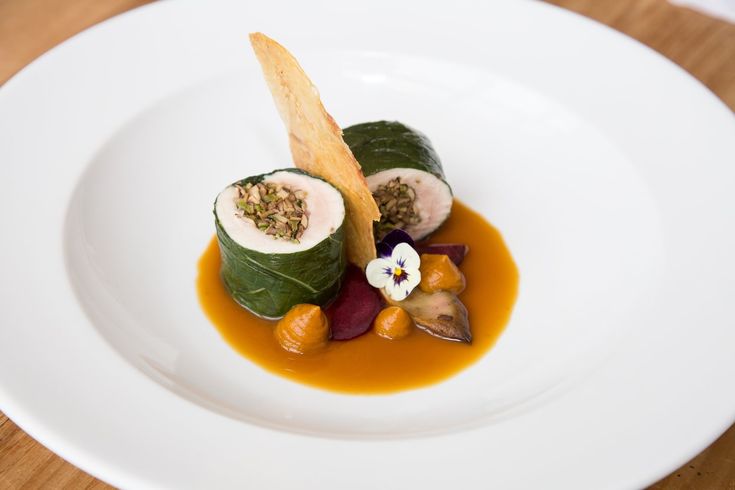 a white plate topped with food on top of a wooden table