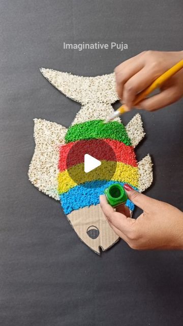 someone is making an art project out of rice and colored pencils on a blackboard