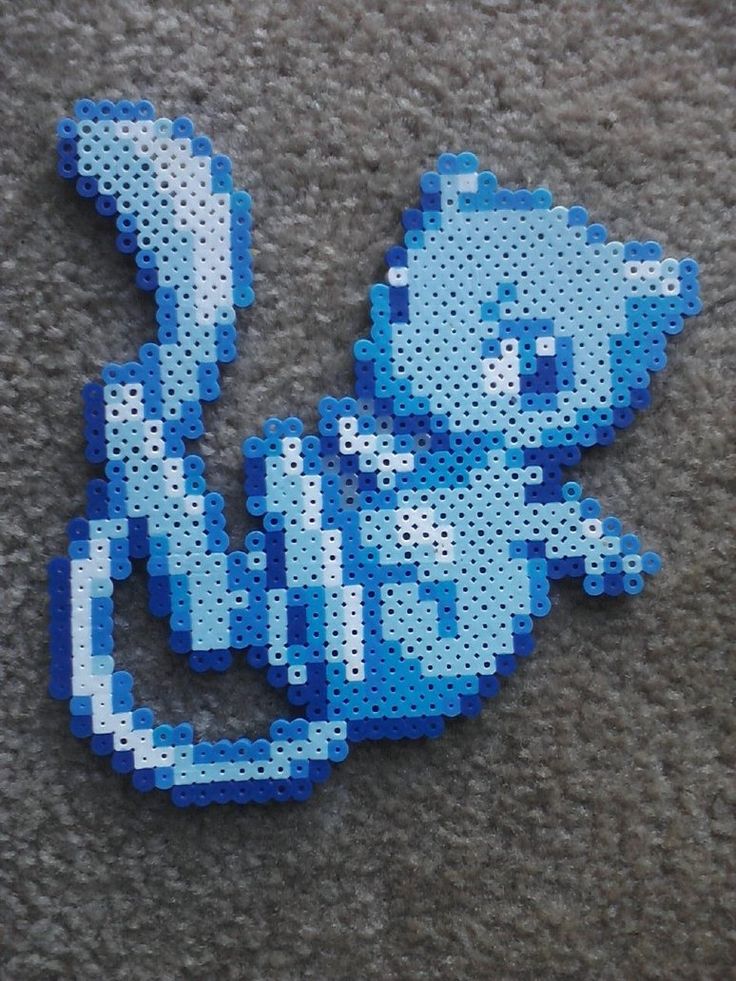 the pixel art is made with blue and white beads, which are shaped like cartoon characters