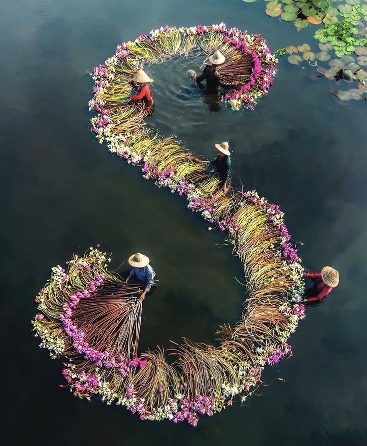 two people in hats are floating on the water