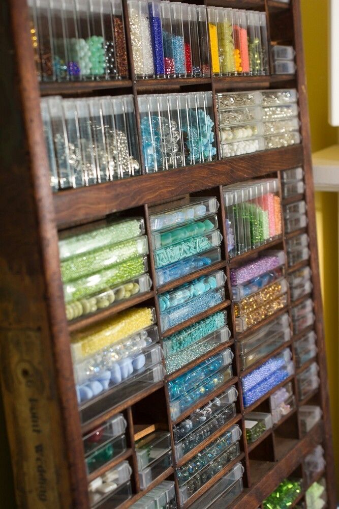 a wooden shelf filled with lots of craft supplies