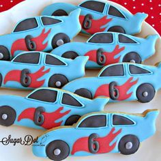 decorated cookies in the shape of cars on a plate