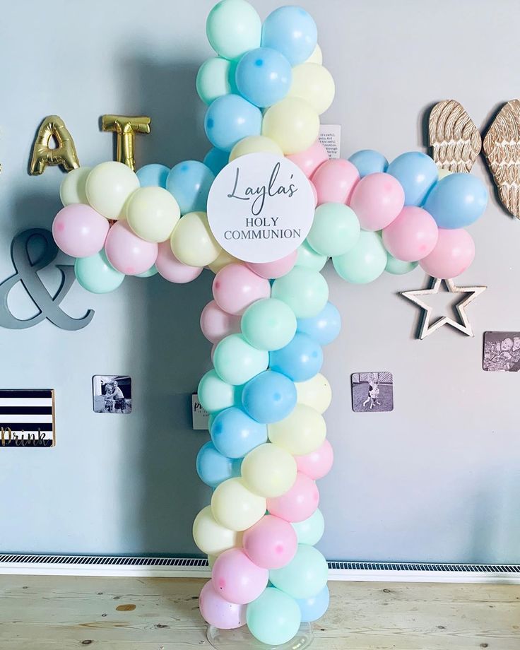 a balloon cross is displayed in front of a wall