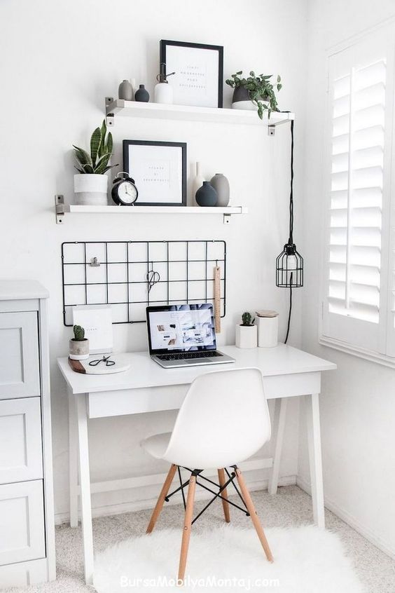 a white desk with a laptop computer on top of it next to a window and potted plants