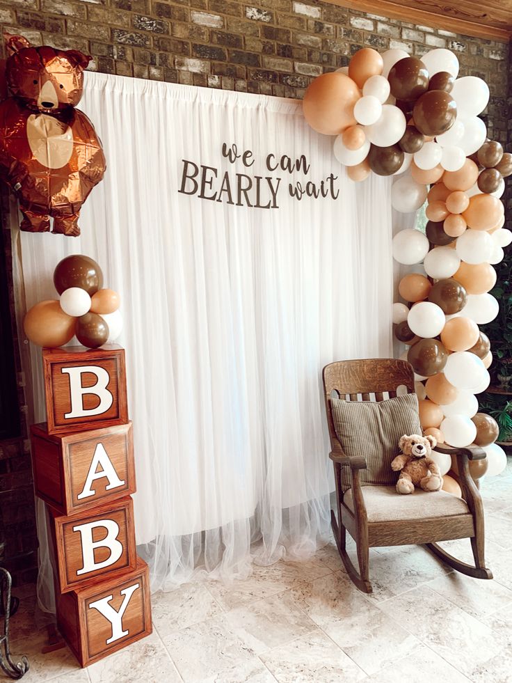 a baby shower is decorated with balloons, teddy bears and wooden blocks for the entrance