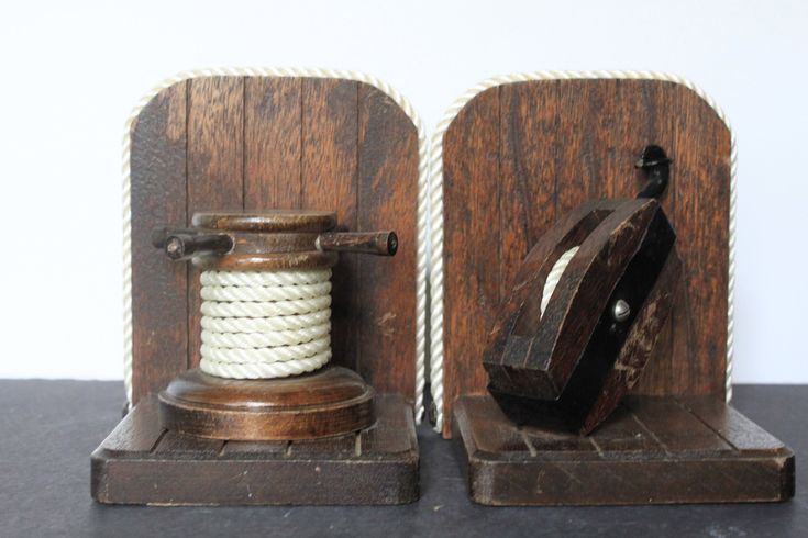 two wooden pieces with rope on them sitting next to each other