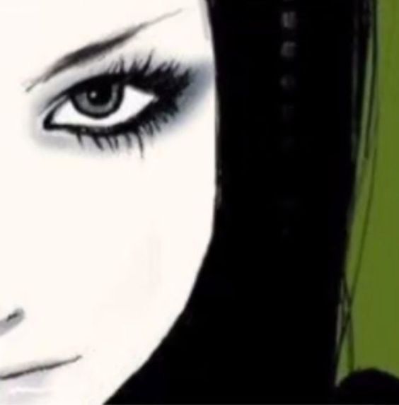 a woman's face with long black hair and green eyeshade, close up