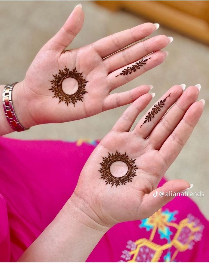 the woman is holding her hands with hendi designs on it's palms