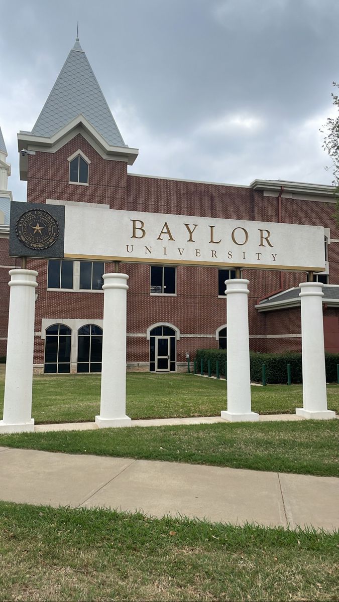 a building with columns and a clock on it's front entrance that says taylor university