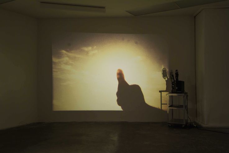 a person's shadow is projected on the wall