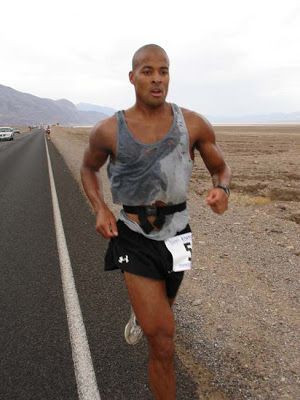 a man running down the road in shorts