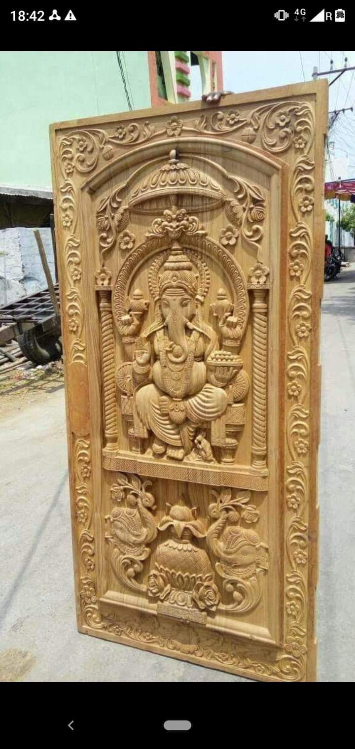 an intricately carved wooden panel depicting the god ganesh